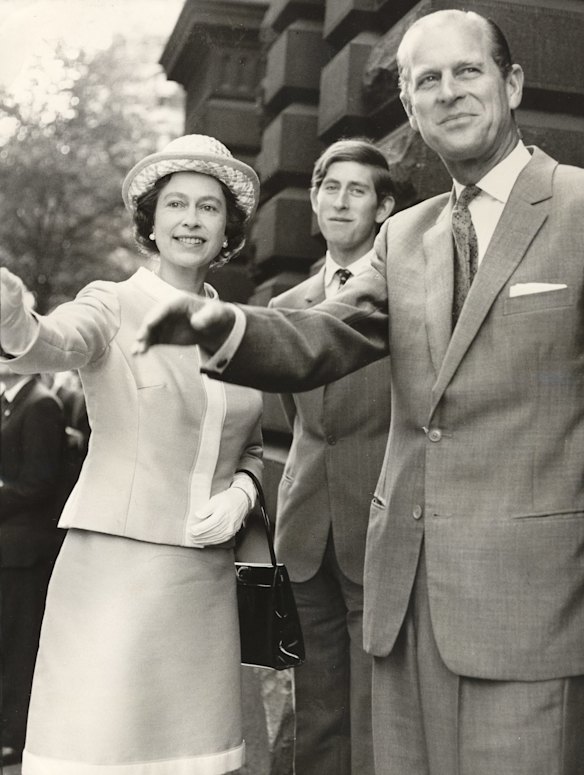 Queen Elizabeth II, Prince Charles and Prince Phillip stop to wave outside the Melbourne Town Hall, 7 April, 1970