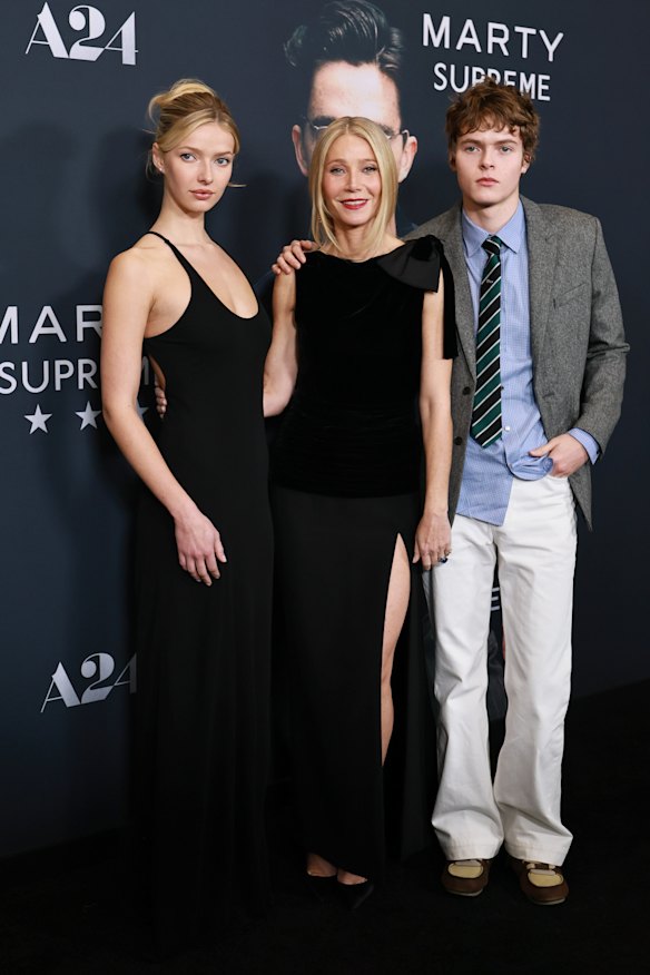 Apple Martin wearing her mother’s vintage Calvin Klein dress, Gwyneth Paltrow in Valentino haute couture and Moses Martin at the New York premiere of Marty Supreme.