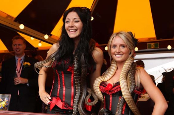 Karolina Soprun and Stephanie Wilson draped with snakes in the Birdcage.