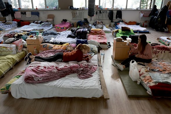 Evacuees relax at a centre for displaced people set up in a gymnasium in Lviv. 