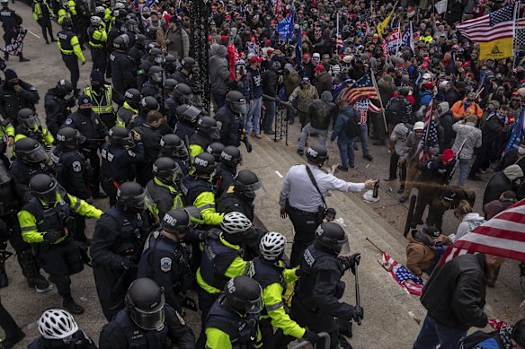 Pepper spray is used against demonstrators as they breach the US Capitol building grounds.