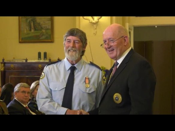Graeme "Duck" Tonge, pictured left, receives a long service award to ACT SES from Govenor General Peter Cosgrove 