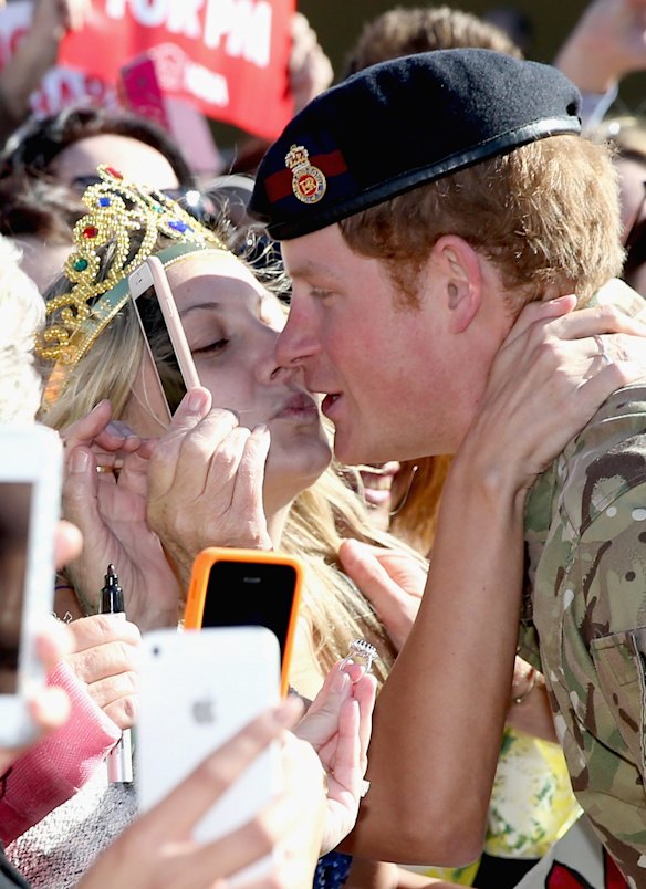 Prince Harry gets kissed by Royal Fan Victoria Mcrae during a walkabout outside the Sydney Opera House 