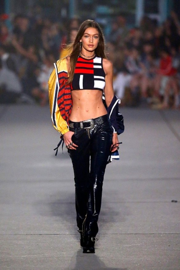 2017- Model Gigi Hadid walks the runway show for her collaboration with Tommy Hilfiger, which brought back some nostalgic noughties vibes in crops and dark low jeans.
