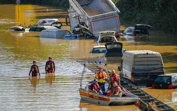 Search and rescue teams are seen on a flooded and damaged part of the highway in a German town. 