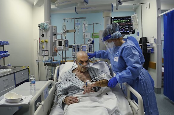 Senior ICU Registered Nurse Gabby McLoughlin cares for a COVID-19 positive patient.