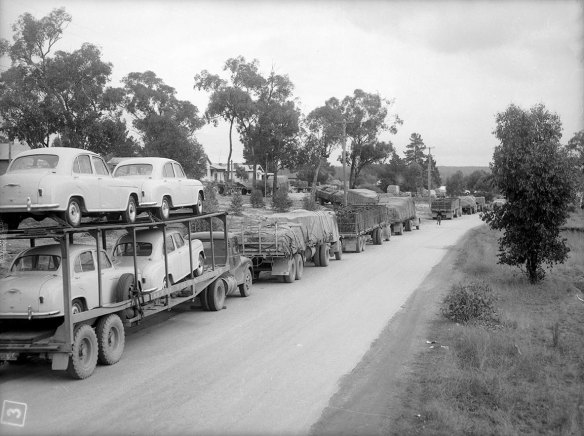 Trucks and drivers stranded on washed out Hume Highway, Wagga Wagga. Taken on 20 July 1956. 