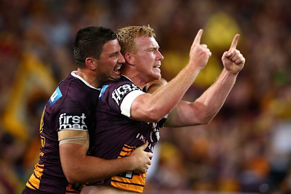 Jack Reed (R) of the Broncos celebrates scoring a try.