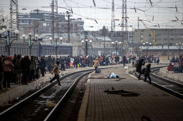 Ukrainians wait on platforms at Lviv-Holovnyi railway station on Sunday for trains to Poland.