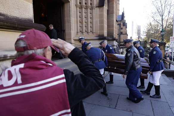 Russell, a Manly fan of 61 years, salutes the the coffin carrying Robert "Bobby" Fulton at St.Mary's Cathedral before the State Funeral in his honour.