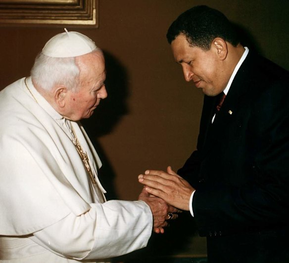 In this Oct. 12, 2001 file photo released by the Vatican, Pope John Paul II shakes hands with Venezuela's President Hugo Chavez during a private audience at the Vatican City Friday.