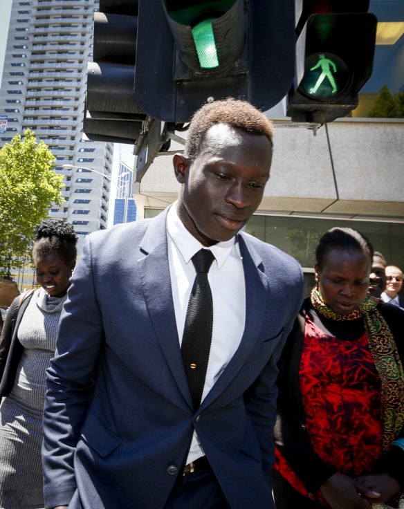Daw walks: North Melbourne's Majak Daw with his mother Elizabeth after leaving the County Court on Thursday. 