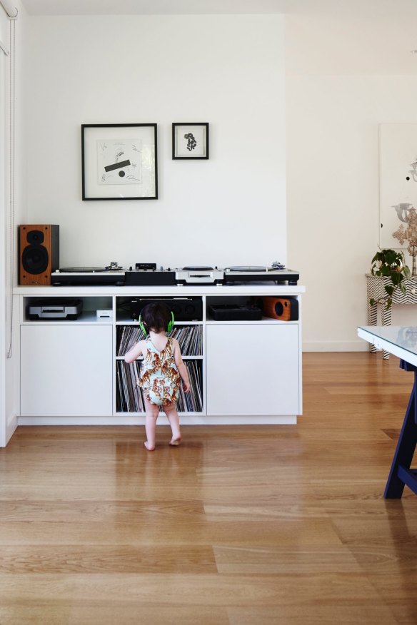 Headphones clamped to her ears, Sloan dances to her dad’s collection of vinyl albums. “I had the shelves custom-made to fit my records,” says Luke.