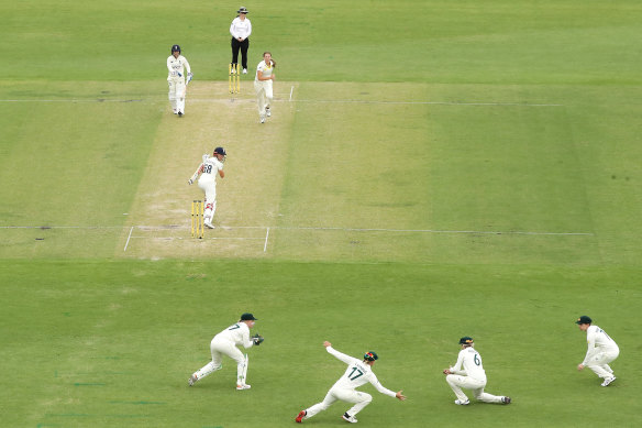 Beth Mooney takes a catch as Australia and England play to a tense draw at Manuka Oval.