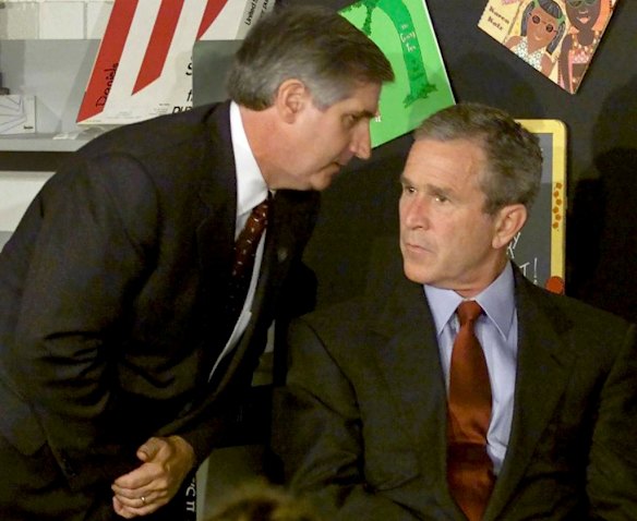 U.S. President George W. Bush listens as White House Chief of Staff Andrew Card informs him of a second plane hitting the World Trade Center while Bush was conducting a reading seminar at the Emma E. Booker Elementary School in Sarasota, Florida in this September 11, 2001 photo.