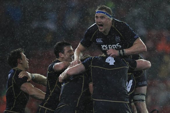 Rain?? What rain?? Scotland celebrate their win over Australia.