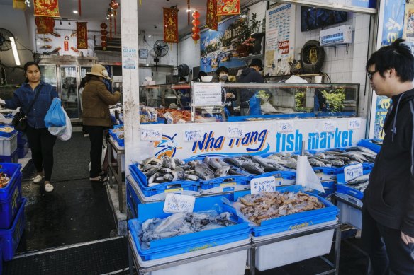 Customers check out the fresh seafood available at the Wha Wang Fish Market.