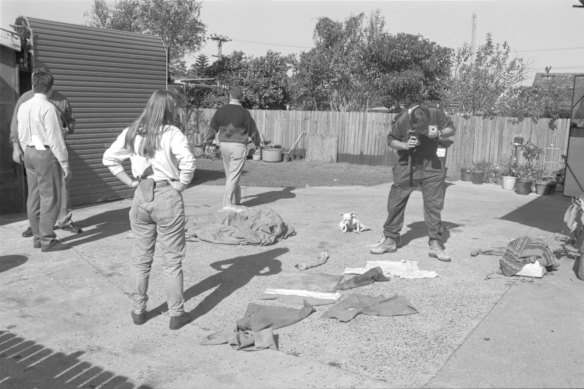 Police, detectives and forensic investigators search the Guilford home of Ivan Milat's mother in 1994. Items believed to be those belonging to victims found in the garage are laid out and photographed.