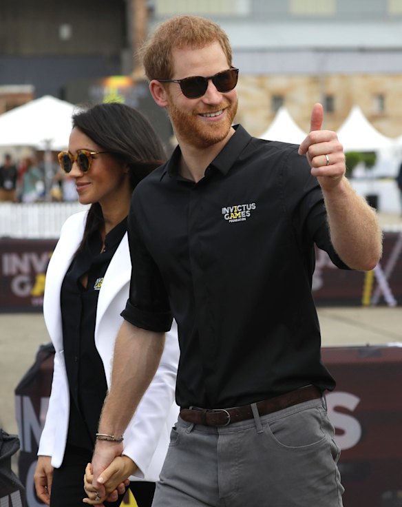 Britain's Prince Harry gestures as he and Meghan, Duchess of Sussex visit the Invictus Games driving challenge on Cockatoo Island in Sydney.