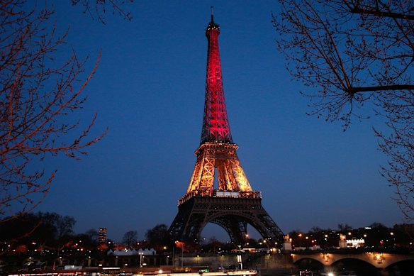 The Eiffel Tower is illuminated with the Belgium national colours black, yellow and red.