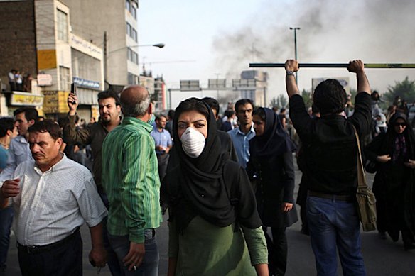 In this photograph posted on the internet, an Iranian woman wears a mask near an anti-government protest in Tehran, Iran Saturday June 20, 2009. (AP Photo)