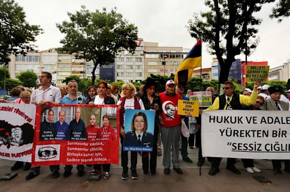 Changing mood: Family and supporters of military servicemen accused of being involved in an attempted coup protest in Besiktas Square in Istanbul.