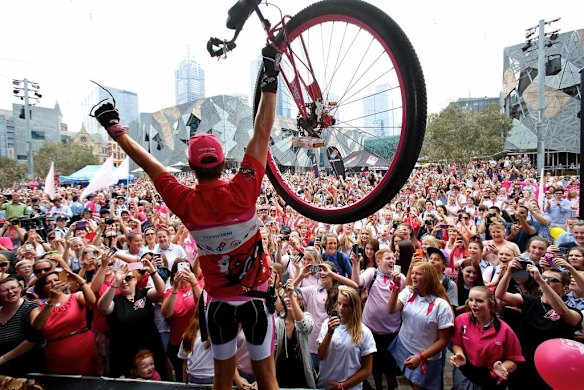 Samuel Johnson celebrates  crossing the finish line after his year-long Love Your Sister unicycle trek.
