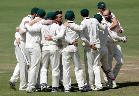 Australia's Steve O'Keefe, center, and teammates celebrate after winning the first cricket test match against India in Pune, India.