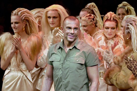 Mugler acknowledges applause following his Fall/Winter 2001-2002 ready-to-wear collection presentation in Paris.