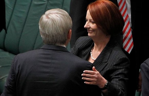 Prime Minister Julia Gillard embraces Foreign Affairs Minister Kevin Rudd after the carbon tax bills passed the House of Representatives.