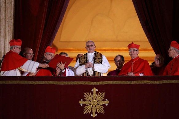 Newly elected Pope Francis appears on the central balcony of St Peter's Basilica.