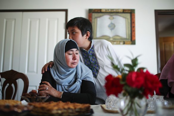 Horigul Yusuf is comforted by her son Hamza Shamseden as she speaks about her brother who remains in China.