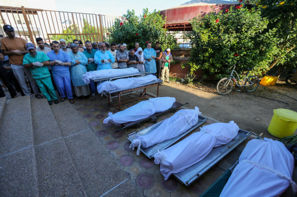 People mourn as they collect the bodies of Palestinians killed in Israeli air raids in Khan Yunis.