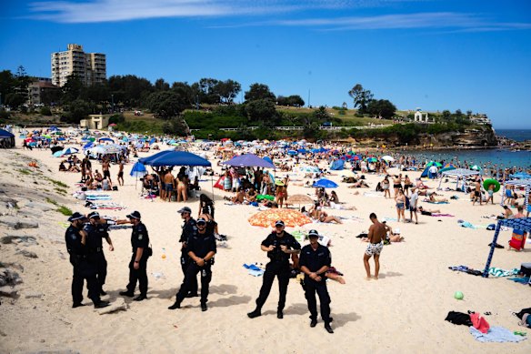 Police on a crowded Coogee Beach on a scorching Australia Day in Sydney. 26th January 2021 Photo: Janie Barrett