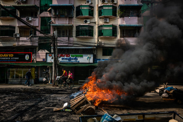 Tyres are set alight by anti-coup protesters at a blockade in Yangon.