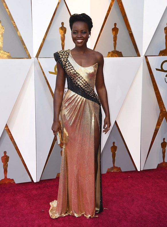 Black Panther's Lupita Nyong'o arrives at the Oscars in Versace. 