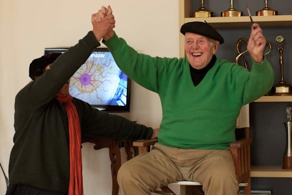 Celebrating the signing of his latest artwork in his Robertson studio.