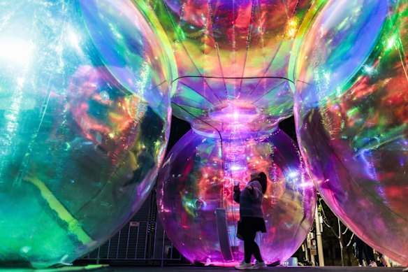 A young child explores the Ephemeral Oceanic exhibit at Walsh Bay as Vivid lights up for 2022 
