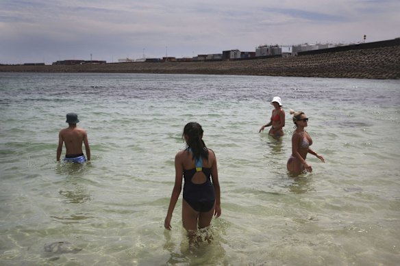 Crowds find refuge from the oppressive heat, swimming at Yarra Bay.