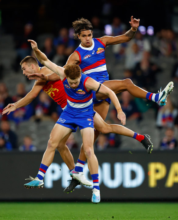 Jack Payne of the Lions, Oskar Baker of the Bulldogs and Jamarra Ugle-Hagan of the Bulldogs in action.