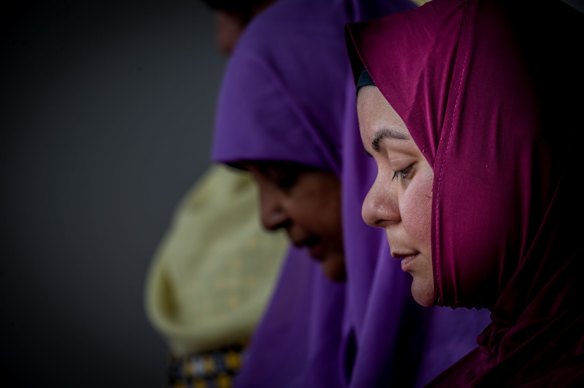 Muslim women Mai Shouman, Meherun Nisa and Rita Joyan pray at Gungahlin Mosque on Saturday afternoon, after terror attacks at mosques in New Zealand on Friday.