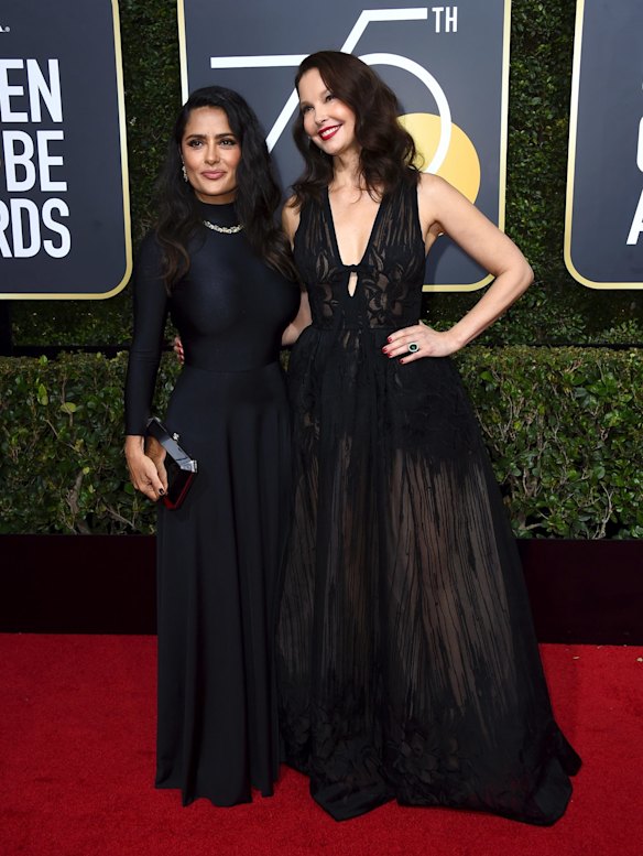 Salma Hayek, left, and Ashley Judd arrive at the 75th annual Golden Globe Awards.