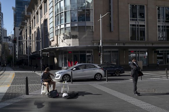 A busker performs near Town Hall. April 5, 2020.