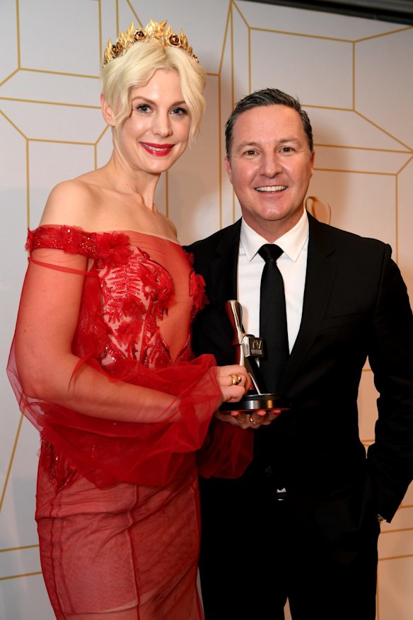 Kate Peck and Matthew White pose for a photograph after Bathurst 1000 won a Logie for the Most Outstanding Sports Coverage