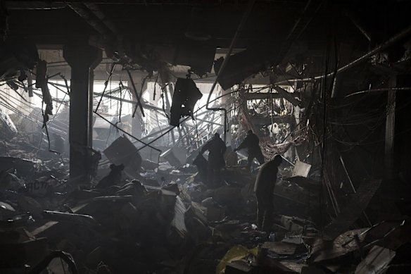 Soldiers and firefighters search for survivors amid debris inside the bombed mall. 