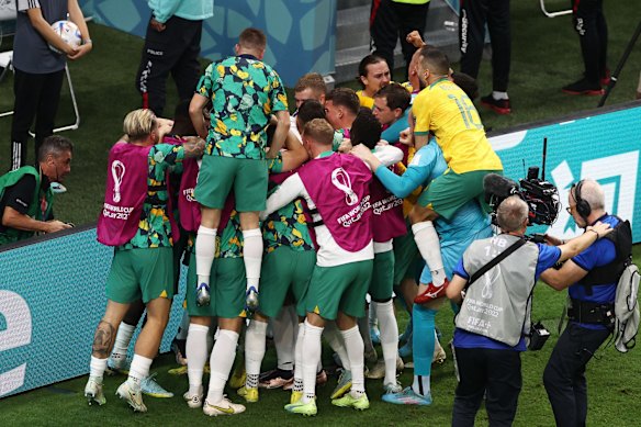 The Socceroos surround Mathew Leckie after he scored for Australia.