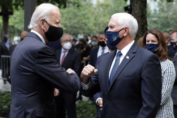 Joe Biden and Mike Pence bump arms at the 9/11 memorial in New York.