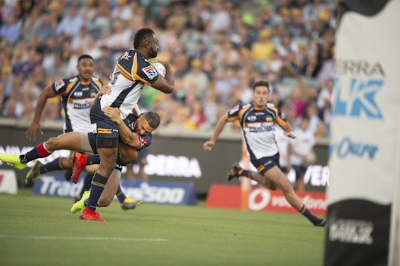 The Rebels' Quade Cooper makes a try-saving tackle on the Brumbies' Tevita Kuridrani. 