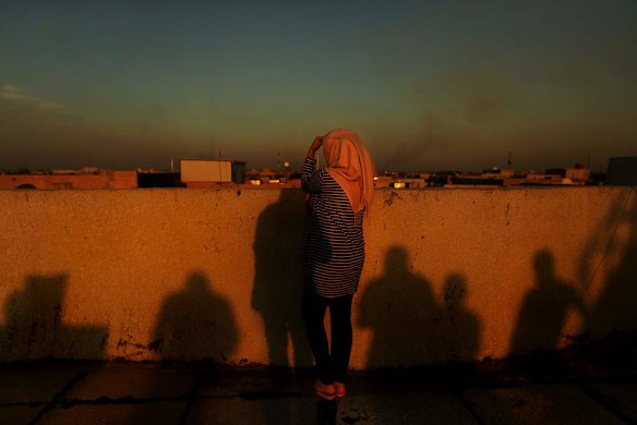 A female internally displaced person (IDP) from Fallujah on a rooftop overlooking Baghdad, Iraq. This woman lived in Fallujah when the Islamic State, also known as ISIS, took over Fallujah. She still has relatives in Fallujah which is still under ISIS control. Baghda, Iraq.