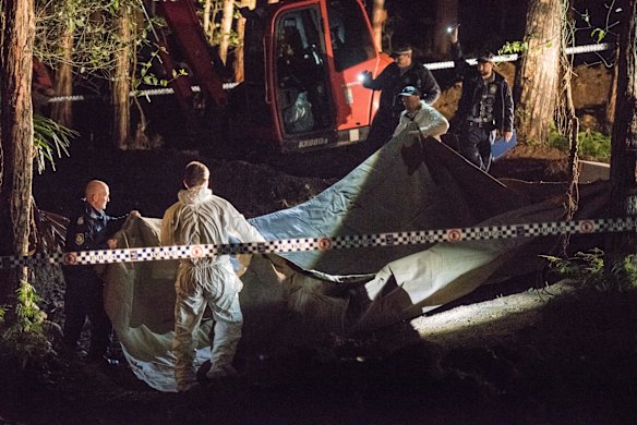 NSW Police and Forensic Services cover the suspected remains of Matthew Leveson.